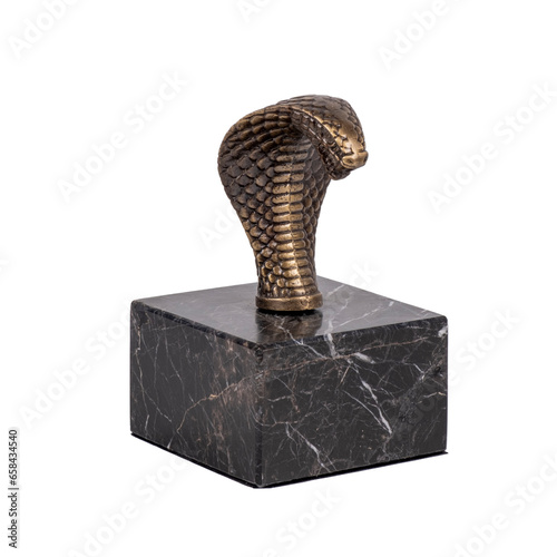 metal cobra snake head figure on black marble luxury decorative object isolated on white background
