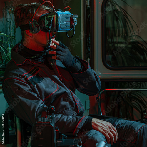 Cybernetization and isolation. A man in a wheelchair with a virtual reality helmet on his head, high technology and a low standard of living of society, concept photo