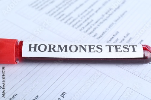 Hormones test. Sample tube with blood on laboratory form, closeup