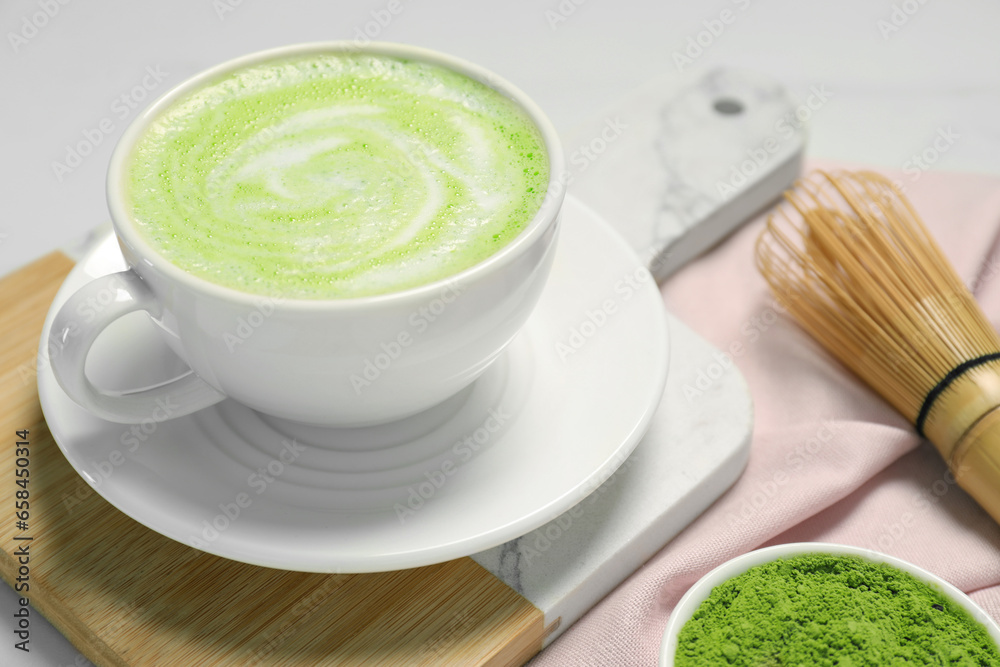 Cup of fresh matcha latte on white table, closeup Cup of fresh matcha latte on white table, closeup