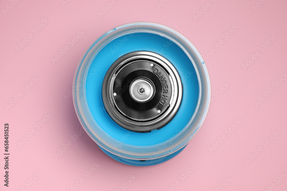 Portable candy cotton machine on pink background, top view Portable candy cotton machine on pink background, top view