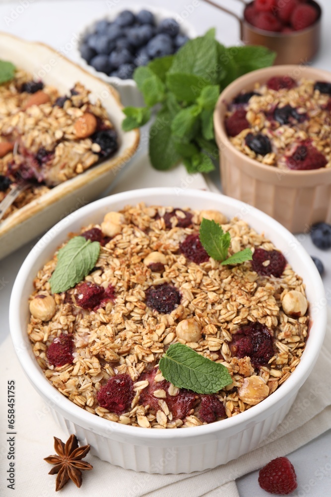 Tasty baked oatmeal with berries, nuts and anise star on table Tasty baked oatmeal with berries, nuts and anise star on table