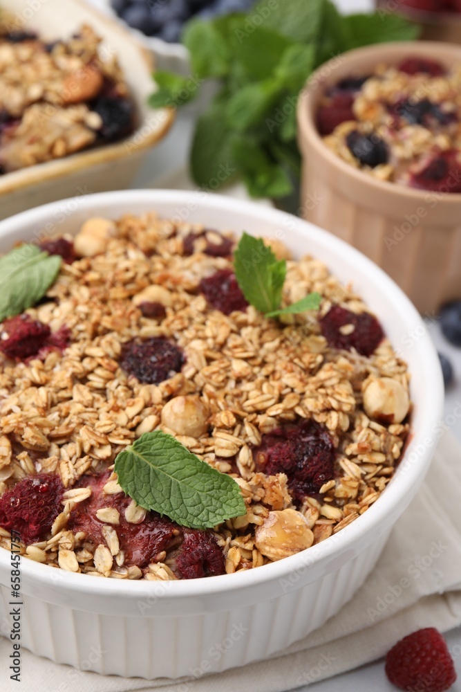 Tasty baked oatmeal with berries and nuts on table, closeup Tasty baked oatmeal with berries and nuts on table, closeup