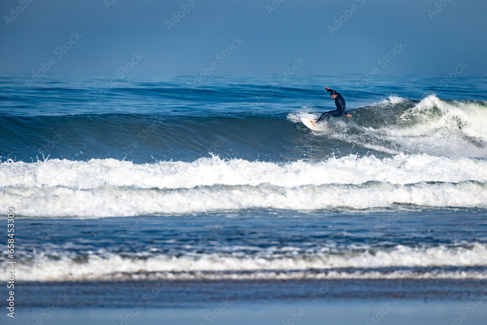 Surfer riding waves in Furadouro Beach