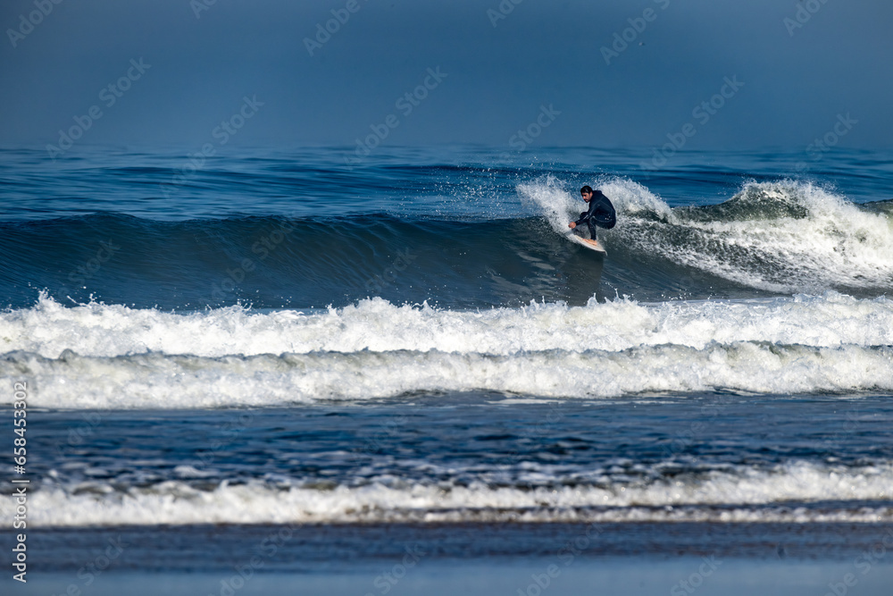 Surfer riding waves in Furadouro Beach