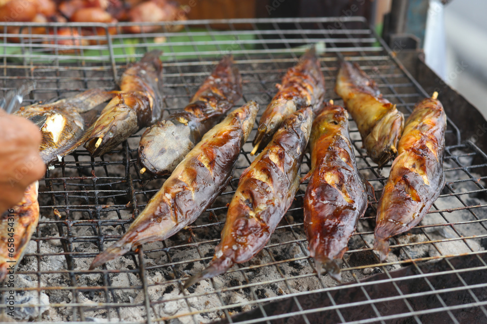 fresh grilled fish is being prepared on the street in Vietnam