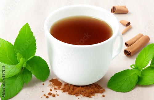 Cinnamon and mint alogn with fresh tea on white background