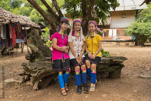 portrait of three long-necked Karen women with brass neck rings at Pai in Mae Hong Son, Thailand