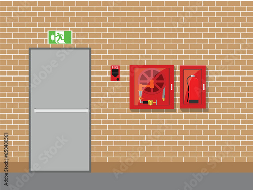 Fire exit with fire extinguisher and red alarm on brick wall background