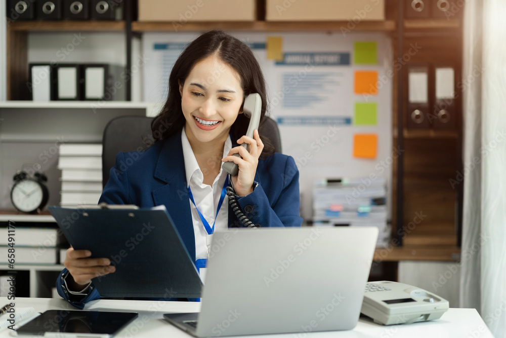 Business women talk mobile phones and working on laptop computers, online business, work from home, teleworking concept. Business women talk mobile phones and working on laptop computers, online business, work from home, teleworking concept.