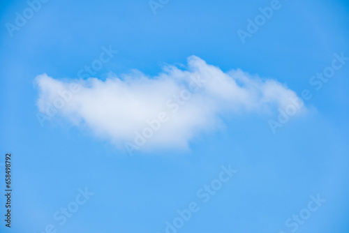 beautiful blue sky and white fluffy single cloud with sunrise in the morning, natural background