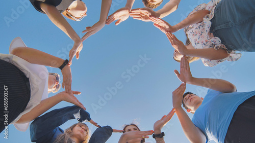 School friends make a big circle with their hands.