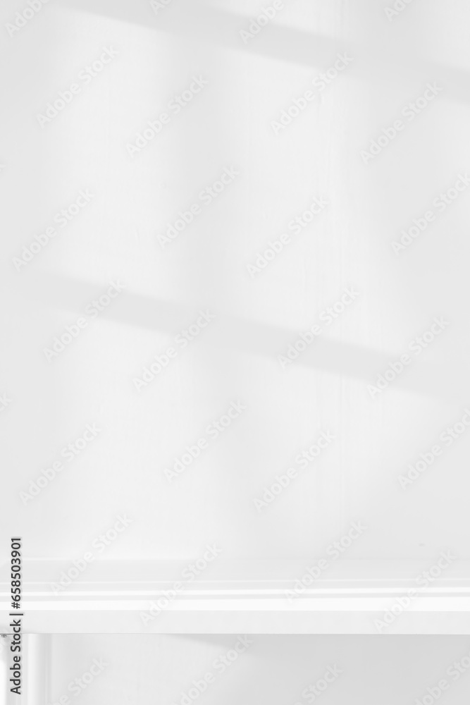 Empty white desk with morning light and shadows of windows with copy space, summer concert. Blurred backdrop abstract background for display product. Empty white desk with morning light and shadows of windows with copy space, summer concert. Blurred backdrop abstract background for display product.