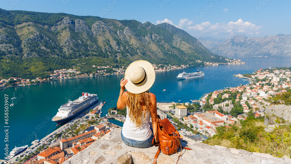 Woman tourist enjoying panoramic view of Kotor Bay- travel, tour tourism, vacation in Montenegro, Europe - obrazy, fototapety, plakaty 