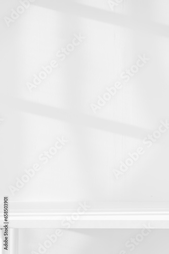 Fototapeta Naklejka Na Ścianę i Meble -  Empty white desk with morning light and shadows of windows with copy space, summer concert. Blurred backdrop abstract background for display product.