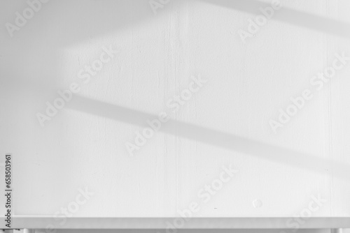 Empty white desk with morning light and shadows of windows with copy space, summer concert. Blurred backdrop abstract background for display product.