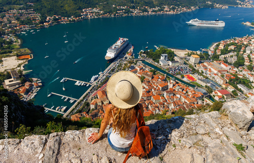 Traveler young female looking at panoramic view of Kotor Bay- travel, tour tourism, vacation in Montenegro, Europe