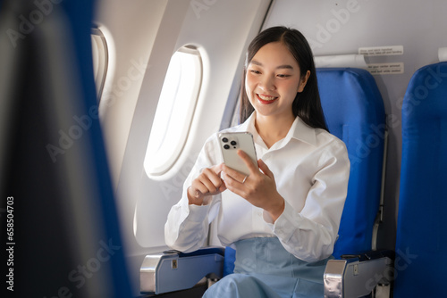 Texting on mobile chat app, Thoughtful asian people female person onboard, airplane window, perfectly capture the anticipation and excitement of holiday travel. chinese, japanese people.