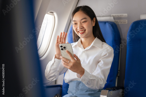 Video call on mobile, Thoughtful asian people female person onboard, airplane window, perfectly capture the anticipation and excitement of holiday travel. chinese, japanese people.