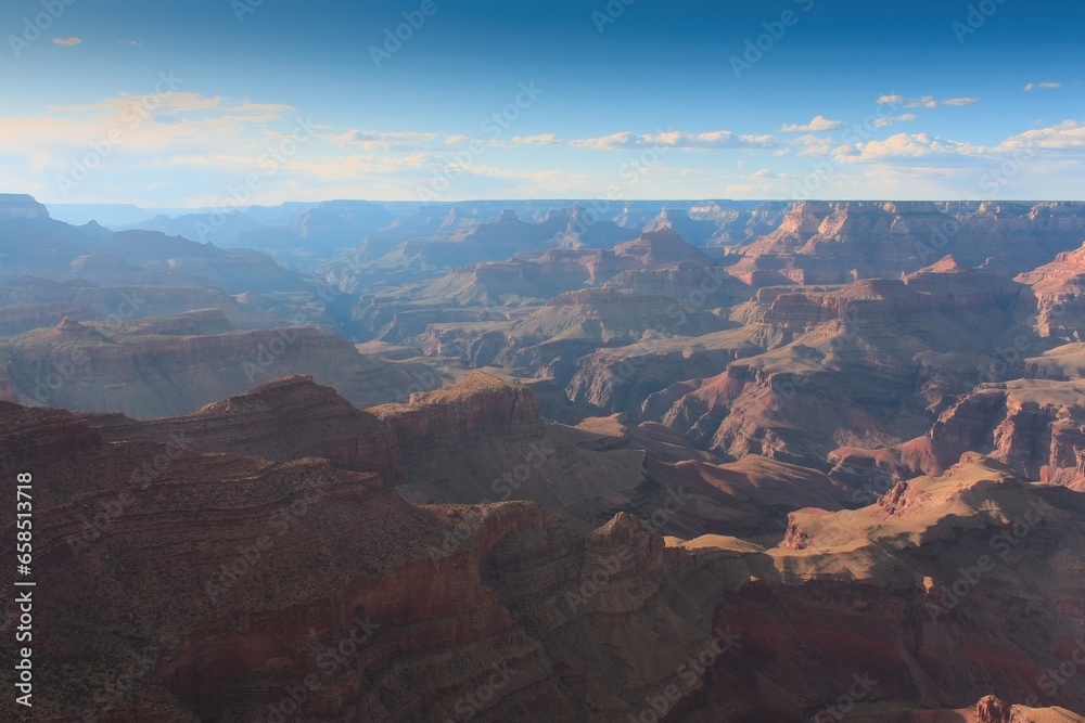 The Grand Canyon, Arizona. White clouds are in a blue sky.