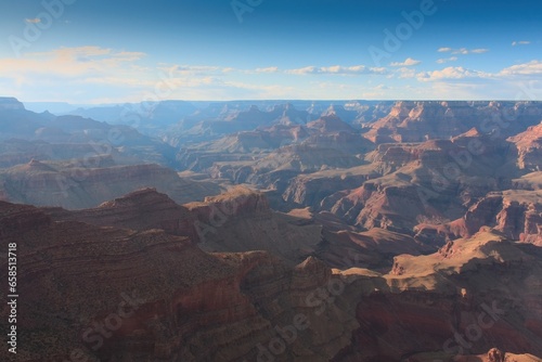 The Grand Canyon, Arizona. White clouds are in a blue sky.