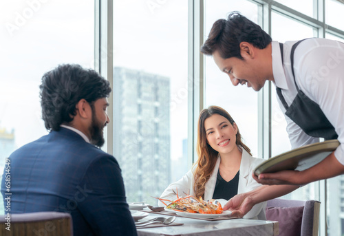 Arab couple lover dating and take a linch in Italian restaurant photo