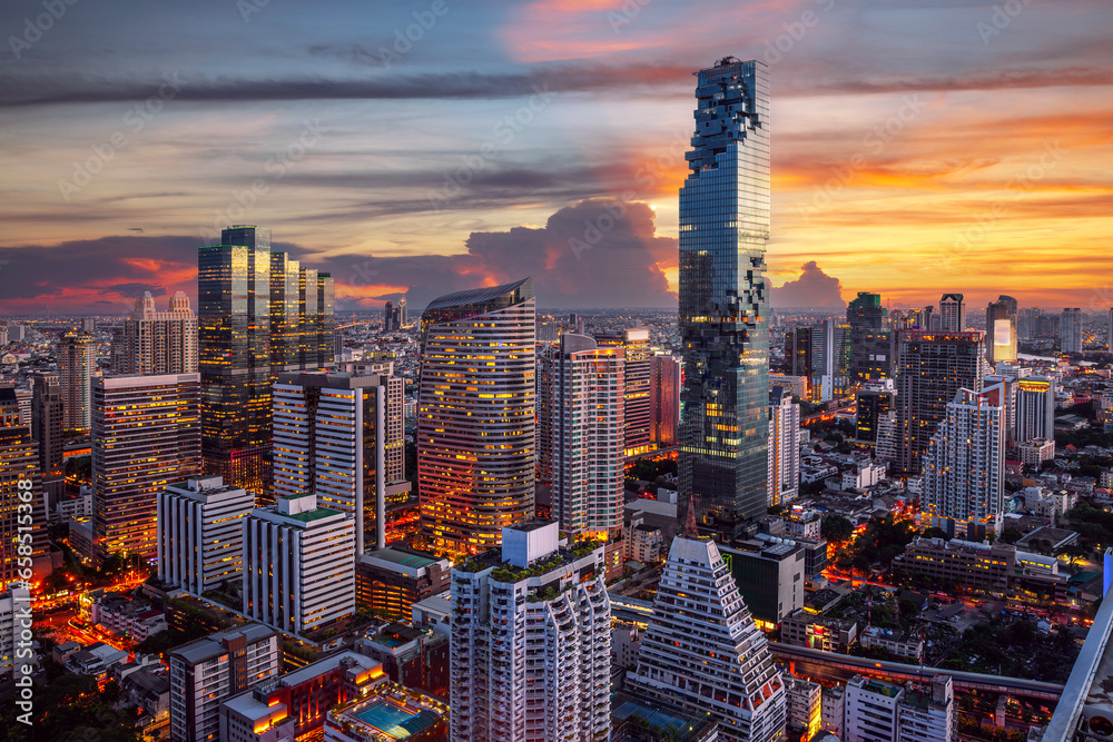 Naklejka premium highest Building in bangkok city with sunset sky in silom district area