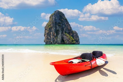 Kayak boat on the beach with poda island background and blue sky