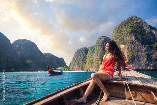 Asian travel woman relax on the traditional long tail boat with maya bay © anekoho