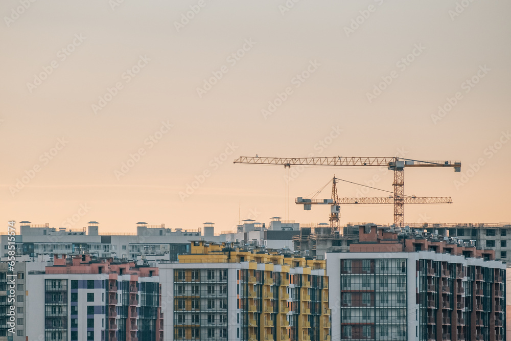 Cranes and building with evening sky background