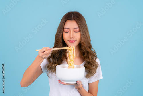 Asian woman eating hot quick instant noodles
