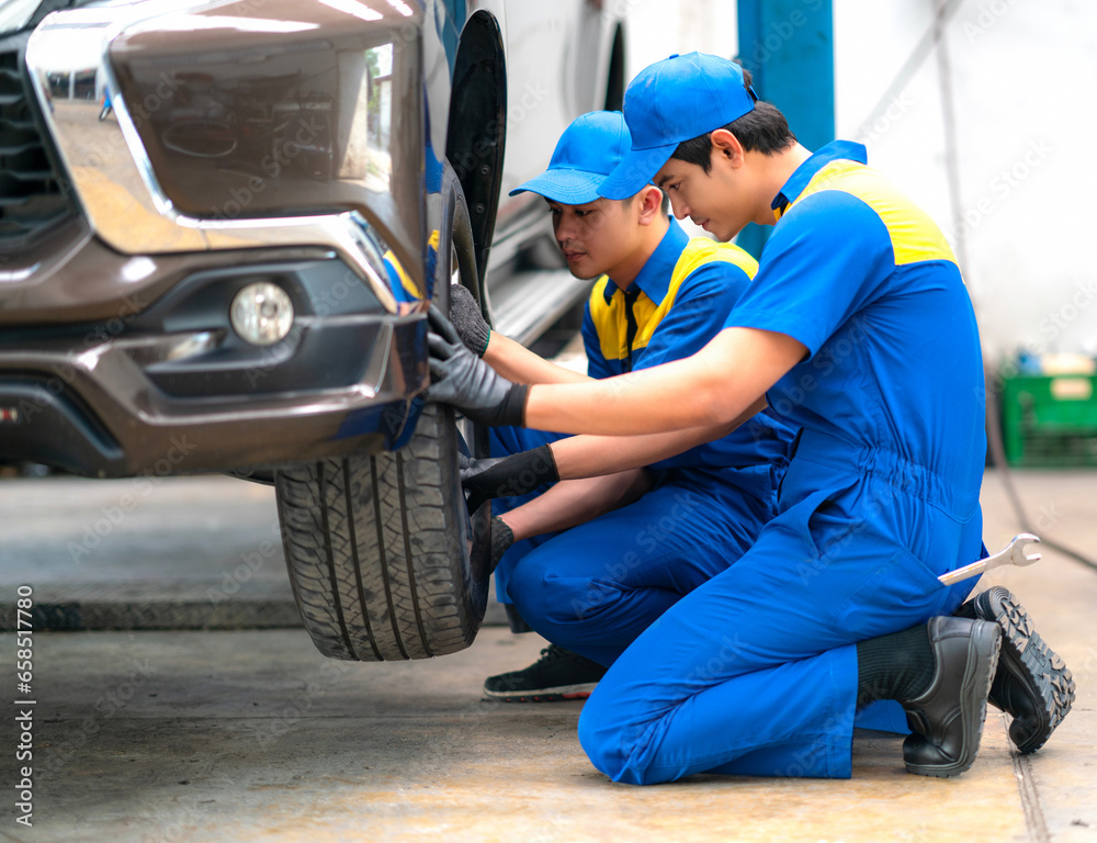 repairman and technician in car garage service in blue uniform repairman and technician in car garage service in blue uniform