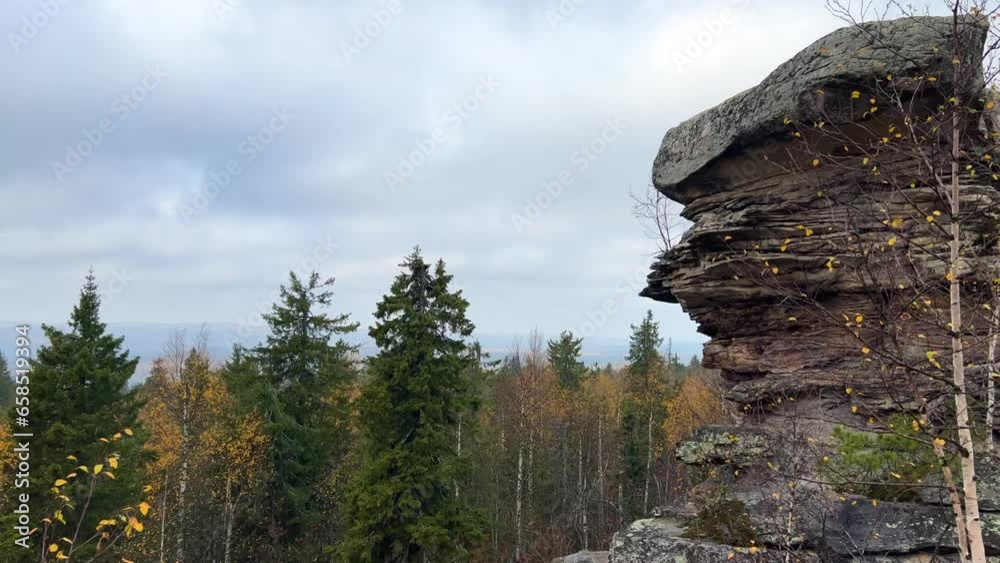 Stone City in autumn. Bright foliage and autumn landscape. The natural landscape is a rock formation in Central Russia, the Urals. A natural monument. Ancient rocky folding in the Ural Mountains. 4K Stone City in autumn. Bright foliage and autumn landscape. The natural landscape is a rock formation in Central Russia, the Urals. A natural monument. Ancient rocky folding in the Ural Mountains. 4K