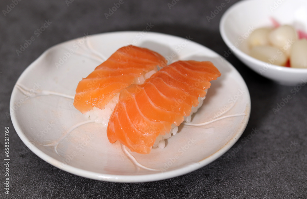 Close-up images of healthy and fresh sushi. Close-up image of salmon sushi on a plate.
