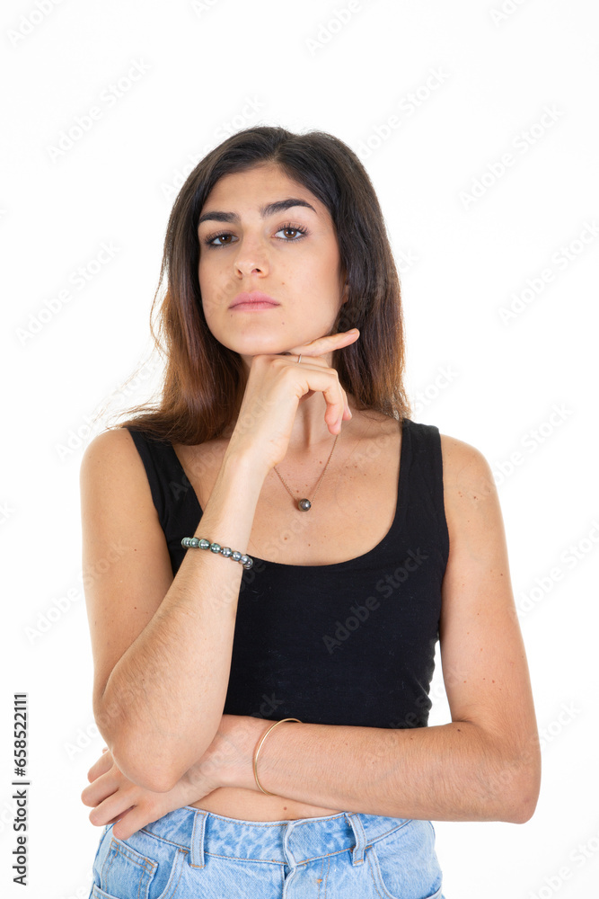 cute beautiful young woman hand on chin posing on white wall background cute beautiful young woman hand on chin posing on white wall background