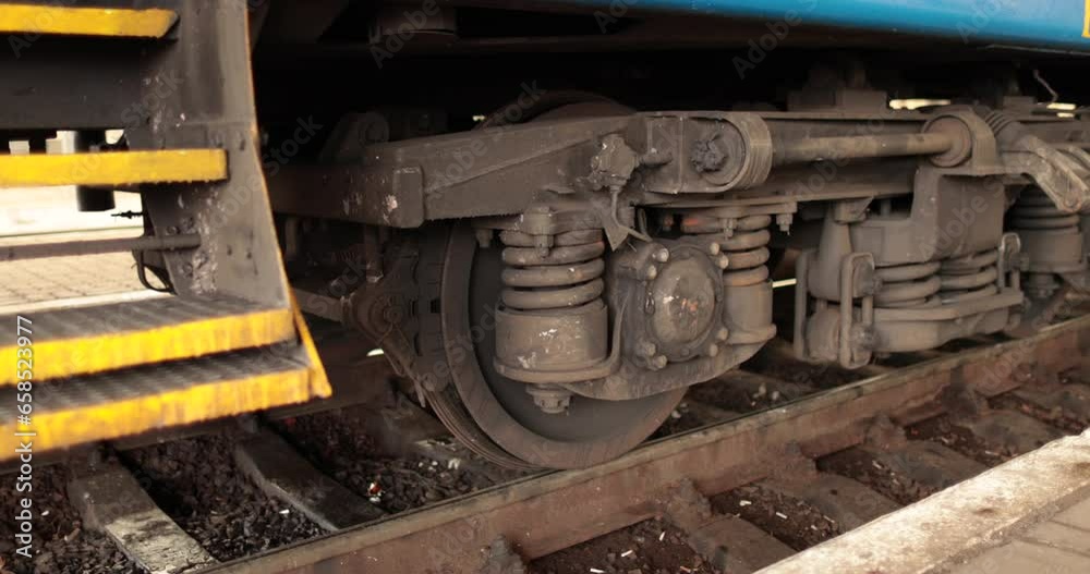 The wheels of a train that started moving from the station. Close-up of the wheels of a moving train. The wheels of a train that started moving from the station. Close-up of the wheels of a moving train.
