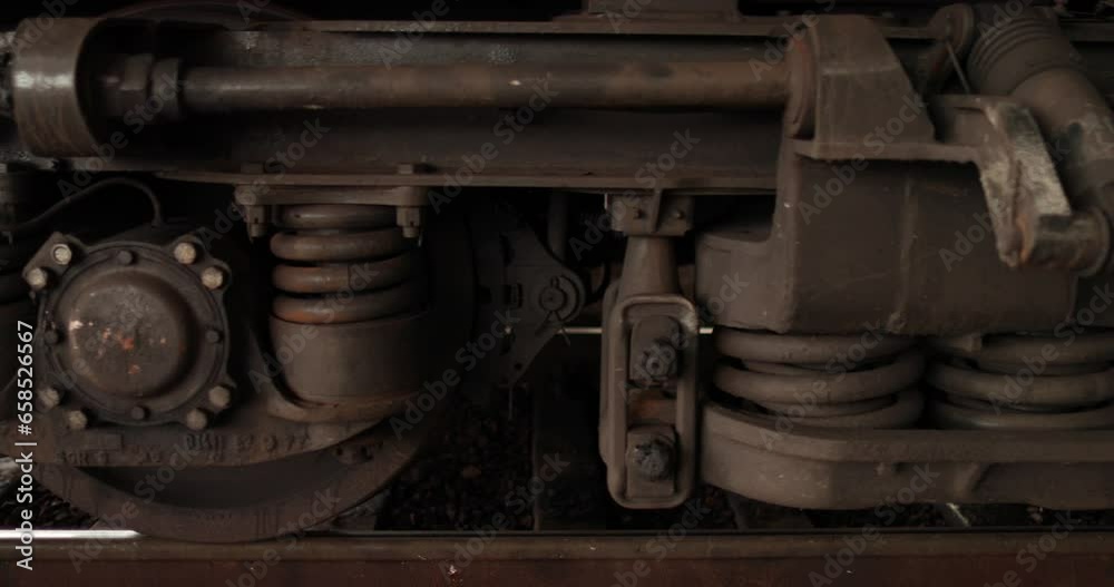 The wheels of a train that started moving from the station. Close-up of the wheels of a moving train. The wheels of a train that started moving from the station. Close-up of the wheels of a moving train.