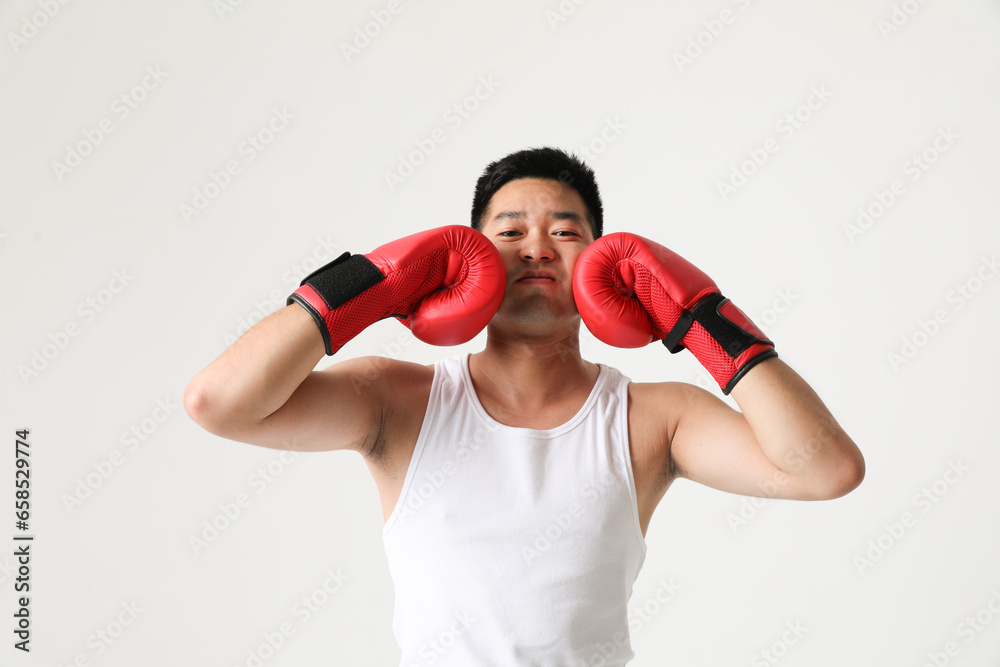 Portrait of young south-asian boxer man wearing red gloves. Horizontal mock-up.