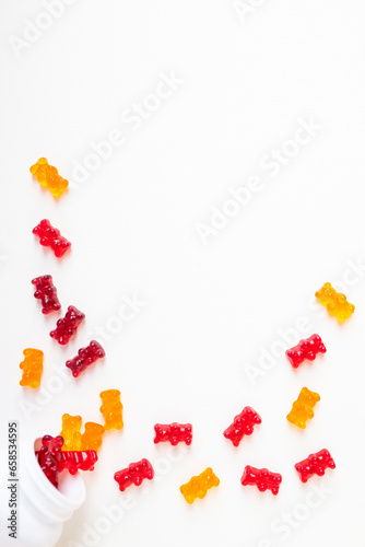 Vitamins and supplements gummy bears  on a white background. Top view, flat lay. 