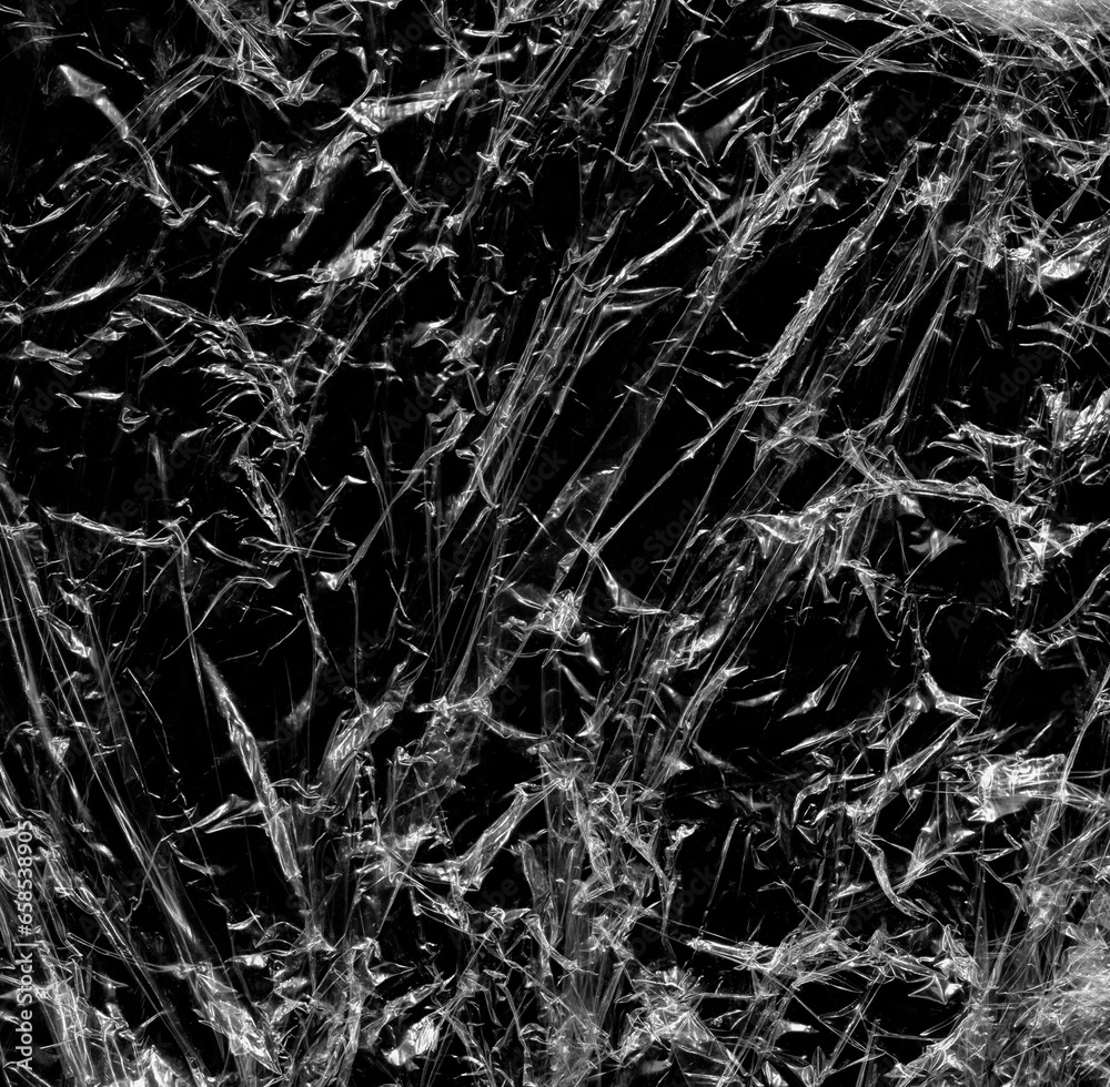 Wrinkled plastic wrap texture on a black background wallpaper. Royalty high-quality free stock photo image of realistic plastic wrap for overlay, copy space and photo effect. Wrinkled plastic surface Wrinkled plastic wrap texture on a black background wallpaper. Royalty high-quality free stock photo image of realistic plastic wrap for overlay, copy space and photo effect. Wrinkled plastic surface