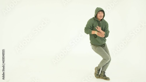 Asian man dancing on white background