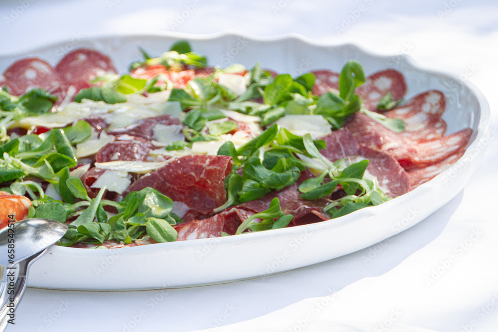 plate of cold meat and arugula plate of cold meat and arugula