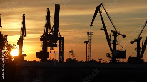A calm Sunday sunset, even the clouds and harbor cranes stand still