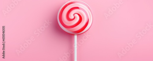 Sweet tasty pink lollipop on a pink background. Generative AI. photo