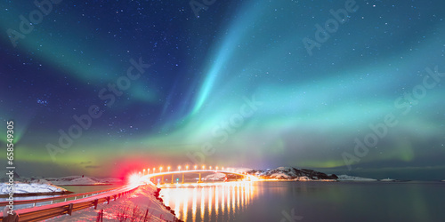 Sommaroy Bridge is a cantilever bridge connecting the islands of Kvaloya and Sommaroy with Aurora Borealis - Hillesoy Tromso Norway
