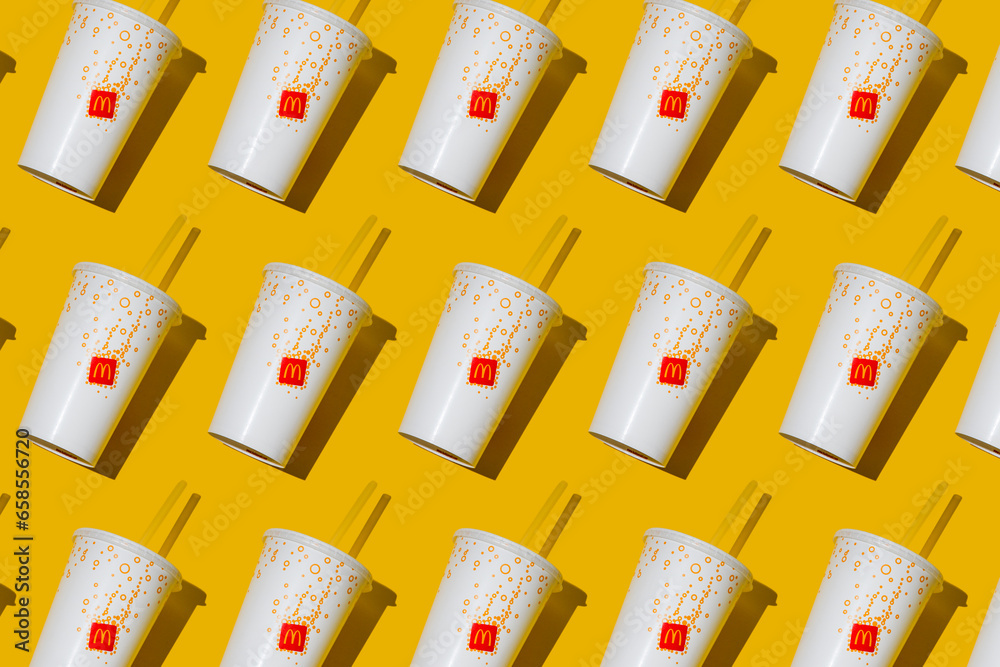 Yellow glass of McDonald's. Paper cup with lid. Takeaway drink ...