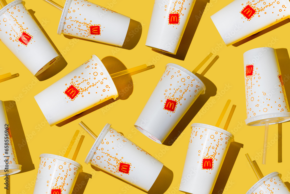 Yellow glass of McDonald's. Paper cup with lid. Takeaway drink ...