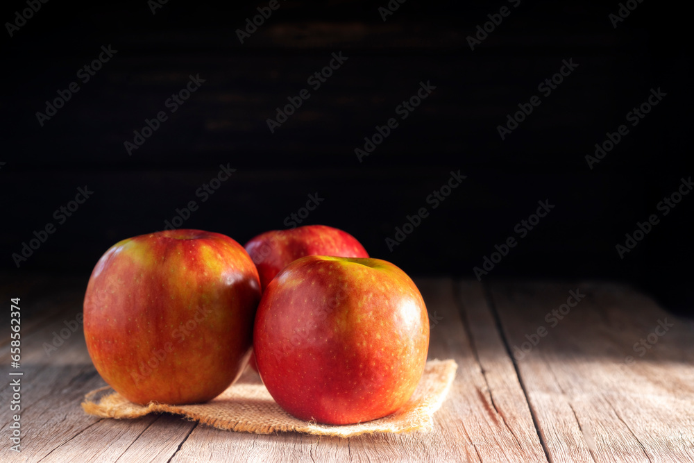Red apples placed on a wooden table healthy fruits black and dark wood background Red apples placed on a wooden table healthy fruits black and dark wood background