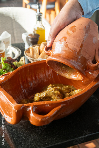 Delicious traditional Moroccan Tanjia dish, served with Moroccan tea ,salad and bread photo