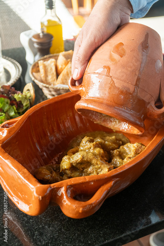 Delicious traditional Moroccan Tanjia dish, served with Moroccan tea ,salad and bread photo